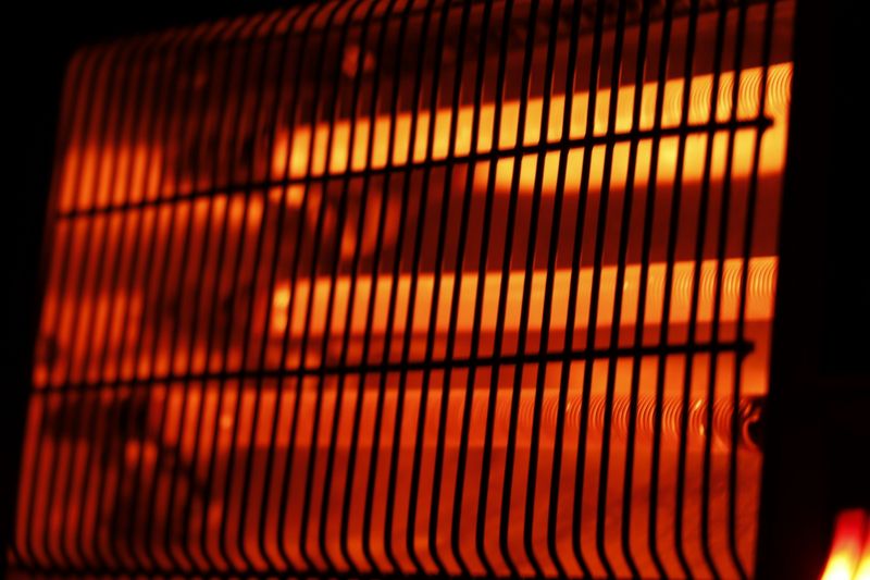 Glowing electric heater element in a dark setting.